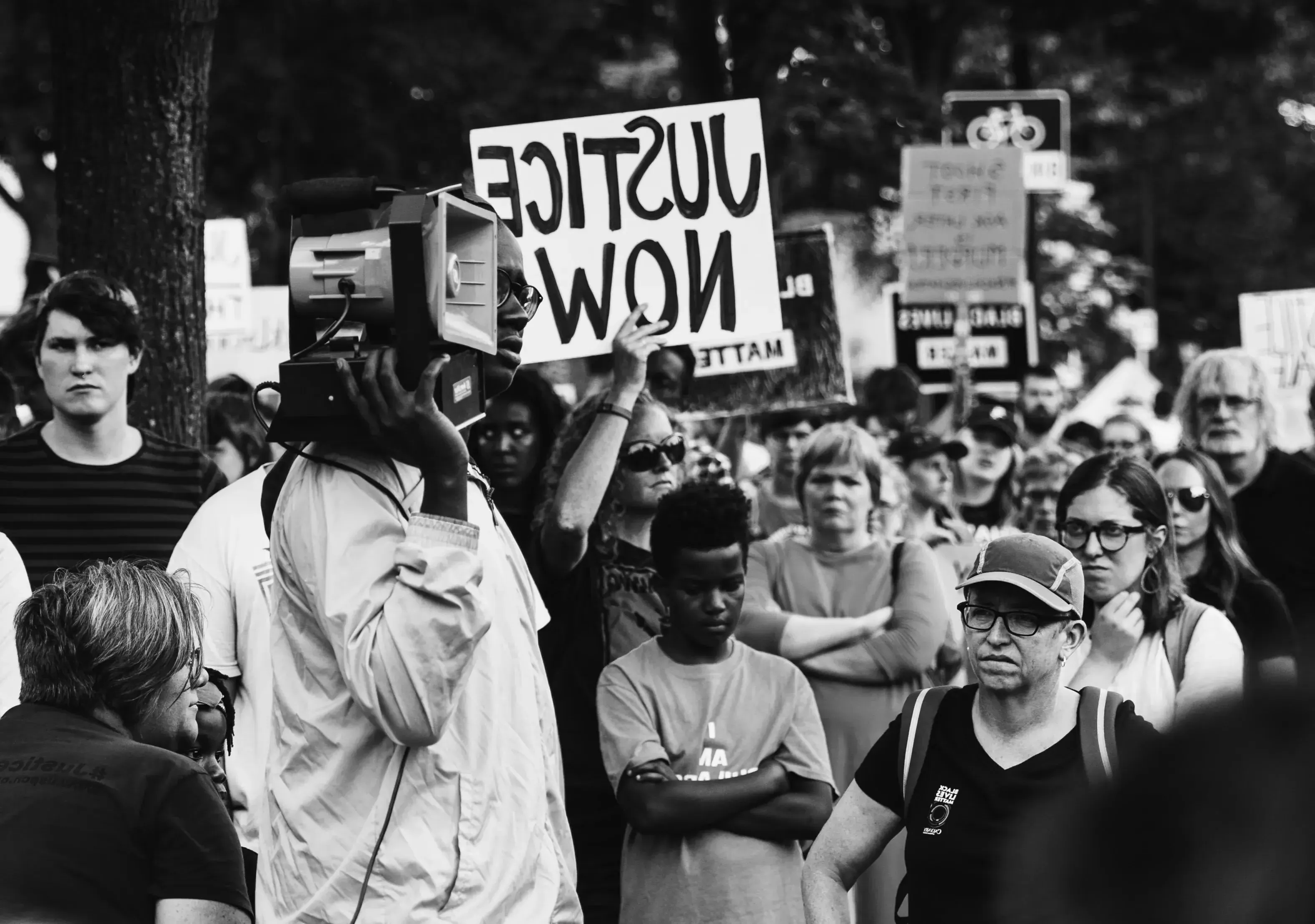 Protests in Minnesota. Woman holding a sign saying "Justice Now."